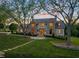 Stunning stone and shingle home boasts mature trees, manicured lawn, and inviting stone walkway at 1641 Legacy Ridge Ln, Wake Forest, NC 27587