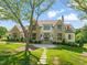 Beautiful home featuring a stone and siding exterior, mature trees, and a stone walkway at 1641 Legacy Ridge Ln, Wake Forest, NC 27587