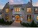 Stunning stone-and-shingle home with an arched front entry and manicured landscaping at 1641 Legacy Ridge Ln, Wake Forest, NC 27587