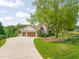 Spacious driveway leading to a two-car garage, with a blend of stone and siding details at 1641 Legacy Ridge Ln, Wake Forest, NC 27587