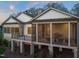 Spacious screened porch featuring a fireplace, TV, and outdoor dining area at 1641 Legacy Ridge Ln, Wake Forest, NC 27587
