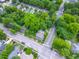 An aerial view of the property showcasing the lush green landscape, nearby houses, and street crossings at 527 S East St, Raleigh, NC 27601