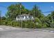 Street view of a white house with overgrown shrubbery on a sunny day, showing the street at 527 S East St, Raleigh, NC 27601