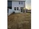 Backyard with screened porch and unfinished landscaping at 1328 Bessie Ct, Wake Forest, NC 27587