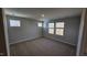 Bedroom with three windows and carpet at 1328 Bessie Ct, Wake Forest, NC 27587