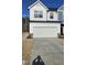 Two-story home with attached garage and landscaped front yard at 1328 Bessie Ct, Wake Forest, NC 27587