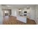 Modern kitchen with white cabinets, island, and stainless steel appliances at 1328 Bessie Ct, Wake Forest, NC 27587
