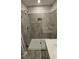 Walk-in shower with gray tile and glass enclosure at 1328 Bessie Ct, Wake Forest, NC 27587
