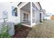 View of the screened-in patio and lush backyard, complemented by the home's exterior and modern AC unit at 567 Marthas Vw Way, Wake Forest, NC 27587