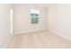 A bright bedroom with carpet flooring and a large window at 567 Marthas Vw Way, Wake Forest, NC 27587