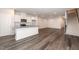 Open kitchen with granite island, stainless appliances, and hardwood floors at 567 Marthas Vw Way, Wake Forest, NC 27587