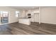 Contemporary kitchen featuring granite counters, stainless appliances, white cabinetry and an island with open access to the living area at 567 Marthas Vw Way, Wake Forest, NC 27587