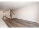Spacious living room with hardwood floors, a staircase, and lots of natural light from the door in the background at 567 Marthas Vw Way, Wake Forest, NC 27587