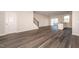 Inviting living room with hardwood floors, a modern staircase, and a bright atmosphere, perfect for relaxation and entertainment at 567 Marthas Vw Way, Wake Forest, NC 27587