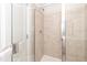 Tiled shower featuring a glass door and a shower head with neutral colored shower tiles at 567 Marthas Vw Way, Wake Forest, NC 27587
