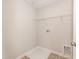 Practical laundry room featuring white shelving, flooring, and hookups for a washer and dryer at 569 Marthas Vw Way, Wake Forest, NC 27587