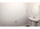 Clean powder room featuring a pedestal sink, modern fixtures, and ample lighting at 569 Marthas Vw Way, Wake Forest, NC 27587