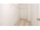Bright walk-in closet with wire shelving and neutral carpet, ready for organizing your wardrobe at 569 Marthas Vw Way, Wake Forest, NC 27587
