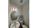Well-lit powder room featuring a sleek vanity with oval mirror, modern fixtures, and a toilet at 115 Shooting Star Trl, Youngsville, NC 27596