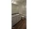 Bright bathroom with a large mirror, tub, and single vanity at 115 Shooting Star Trl, Youngsville, NC 27596