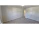 Spacious, carpeted bedroom includes a closet, with a view to the hallway at 115 Shooting Star Trl, Youngsville, NC 27596