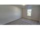 A bright, carpeted bedroom featuring a window with a neighborhood view at 115 Shooting Star Trl, Youngsville, NC 27596