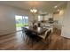 Dining area featuring a modern table, stylish chairs, and sliding glass doors for seamless indoor-outdoor living at 115 Shooting Star Trl, Youngsville, NC 27596