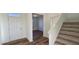 Bright entryway leading into a room with wood-look flooring and a staircase at 115 Shooting Star Trl, Youngsville, NC 27596
