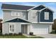 Charming two-story home with a well-manicured lawn and an attached two-car garage at 115 Shooting Star Trl, Youngsville, NC 27596