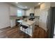 Modern kitchen with white cabinets, stainless steel appliances, and a center island with bar seating at 115 Shooting Star Trl, Youngsville, NC 27596