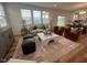 Open-concept living room with stylish seating, a contemporary coffee table, and abundant natural light at 115 Shooting Star Trl, Youngsville, NC 27596