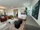 Spacious living area with modern furniture, a large TV, and stylish accents for comfortable living at 115 Shooting Star Trl, Youngsville, NC 27596