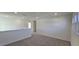 Upstairs loft with neutral carpet and white walls, offering a versatile living space at 115 Shooting Star Trl, Youngsville, NC 27596