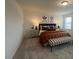 Spacious main bedroom featuring a large bed, neutral decor, and a window for natural light at 115 Shooting Star Trl, Youngsville, NC 27596