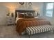 Comfortable main bedroom with a large bed, stylish bedding, and neutral walls for a serene atmosphere at 115 Shooting Star Trl, Youngsville, NC 27596