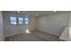 Bright room with carpeted flooring and three windows providing natural light and neighborhood views at 115 Shooting Star Trl, Youngsville, NC 27596