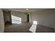 Well-lit room with neutral carpet and a door, offering a versatile space at 115 Shooting Star Trl, Youngsville, NC 27596