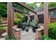 Secluded backyard seating area with a decorative screen and lush plants creates a serene outdoor living space at 1800 Bay Meadow Ct, Raleigh, NC 27615
