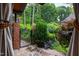 Elegant wrought iron gate leading to a tranquil backyard oasis with stone pathway and lush greenery at 1800 Bay Meadow Ct, Raleigh, NC 27615