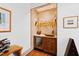 Stylish bar area with custom shelving, wine fridge, and decorative lighting at 1800 Bay Meadow Ct, Raleigh, NC 27615