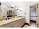 Spacious bathroom with double sink vanity with stone countertops, dark bronze fixtures, and white cabinets at 1800 Bay Meadow Ct, Raleigh, NC 27615