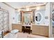 A luxurious bathroom features dual vanities, an ornate chandelier, and a separate makeup vanity area at 1800 Bay Meadow Ct, Raleigh, NC 27615