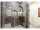 Modern bathroom with a glass-enclosed shower featuring gray tile and updated fixtures for a luxurious experience at 1800 Bay Meadow Ct, Raleigh, NC 27615