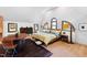 Inviting bedroom featuring arched windows, hardwood floors, lots of natural light, and a comfortable sleeping space at 1800 Bay Meadow Ct, Raleigh, NC 27615