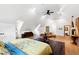 Bright bedroom featuring hardwood floors, pitched ceiling, lots of natural light, and a bed with yellow floral bedding at 1800 Bay Meadow Ct, Raleigh, NC 27615