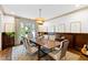 Elegant dining room with a wooden table, unique chandelier, and sophisticated decor at 1800 Bay Meadow Ct, Raleigh, NC 27615
