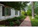 Brick walkway showing exterior paint color and lush landscaping alongside the home at 1800 Bay Meadow Ct, Raleigh, NC 27615