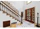 Elegant foyer showcasing a staircase, unique decor, and a striking front door at 1800 Bay Meadow Ct, Raleigh, NC 27615