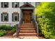 Elegant front entrance with a wood door, brick steps, and manicured greenery at 1800 Bay Meadow Ct, Raleigh, NC 27615