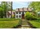 Charming two-story white brick home with manicured landscaping and a stone pathway leading to the entrance at 1800 Bay Meadow Ct, Raleigh, NC 27615